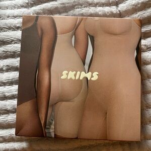 Skims mid-thigh black body suit